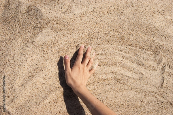 Fototapeta Background with hand on the sand
