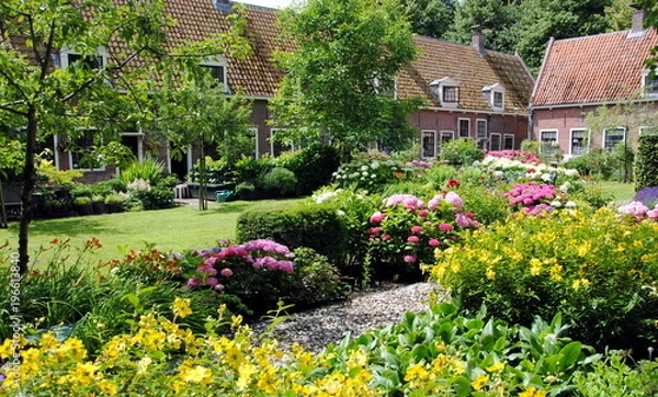 Fototapeta Row of cottages in a big flower garden in Edam, the Netherlands