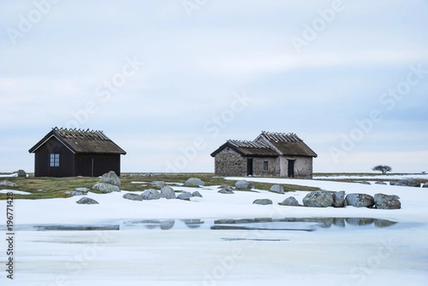 Obraz Old cabins in a barren winter landscape