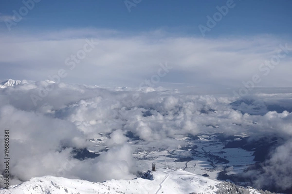 Fototapeta View above clouds on a mountain peak