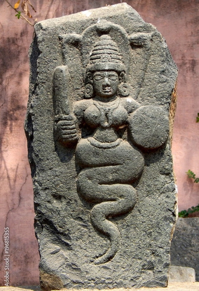 Fototapeta Indian ancient ruins of stone carved Hindu goddess naga  or snake devata 