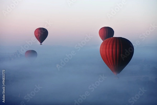 Fototapeta Red balls in the morning in the fog above Bagan. Bagan  is an ancient city located in the Mandalay Region of Myanmar