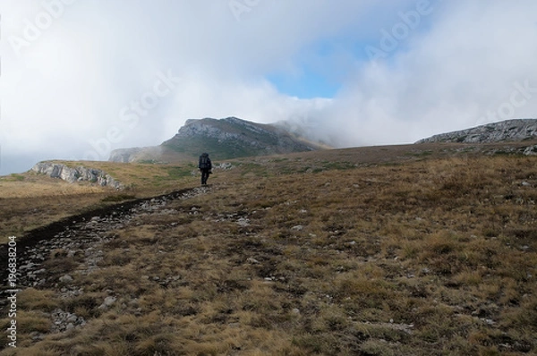 Fototapeta A tourist at the top Crimean Chatyr-Dag mountain in autumn