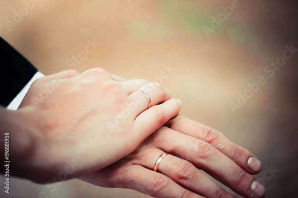 Fototapeta Young married couple holding hands, ceremony wedding day