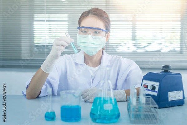 Fototapeta Professional distinguished Science specialist at work.Young Asian scientist with test tube making research in clinical laboratory.Innovative technologies in science and medicine