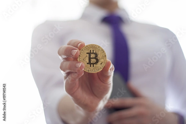 Fototapeta Business woman offers gold bitcoin coin. Digital Financial Bit Coin ICO Technology.