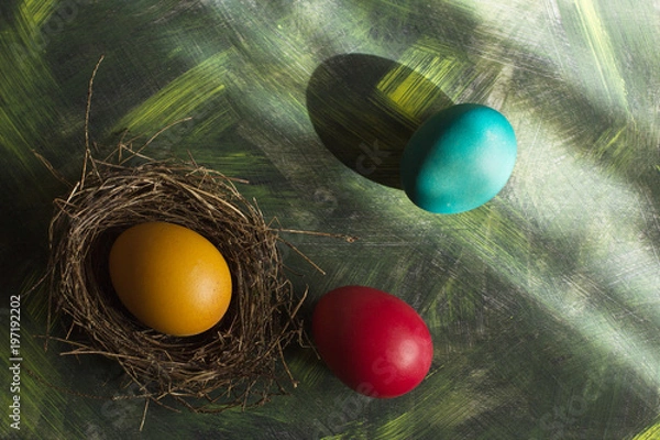 Fototapeta Three multi-colored Easter eggs on a motley background.