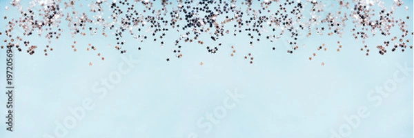 Obraz Star shaped silver sequins over blue background banner. Copy space.