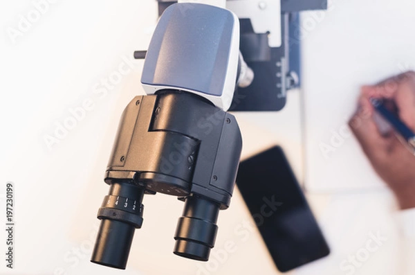 Fototapeta close up of man using microscope