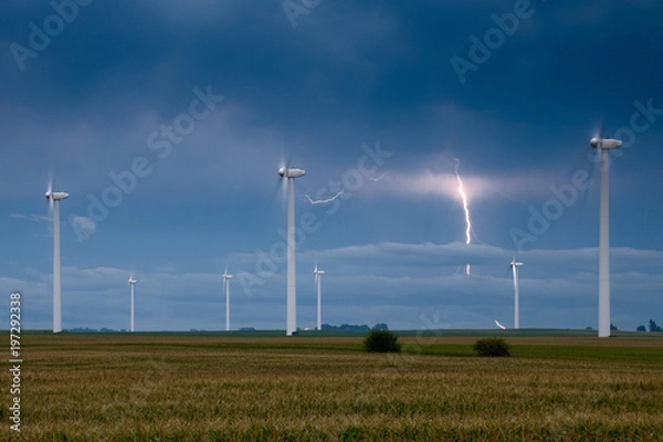 Fototapeta Wind turbines with a lightning bolt on the background