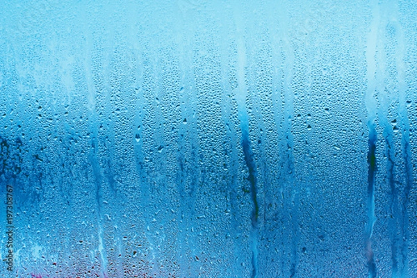 Obraz Blue background of natural water condensation, window glass with high air strong humidity, large drops drip. Collecting and streaming down