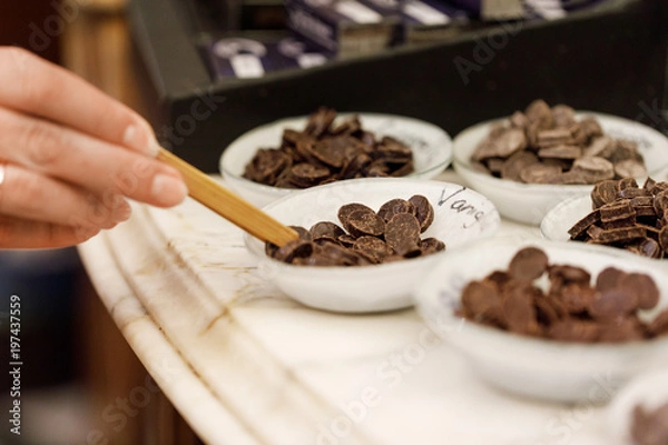 Fototapeta Chocolate drops in bows used as to sample the tast of chocolate 