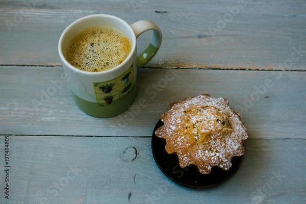 Obraz cup of coffee and a cupcake on a plate