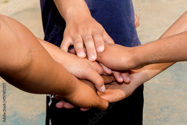 Fototapeta Human hands unity with their hands together ,concept successful business people