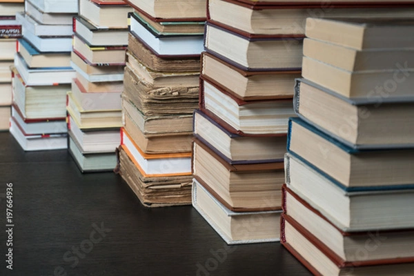 Fototapeta Many books in a bookstore or library on wooden background with copy space