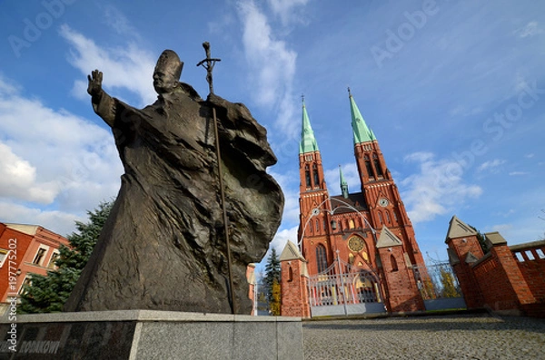 Fototapeta Statue of John Paul II against the background of the cathedral (Rybnik, Poland)