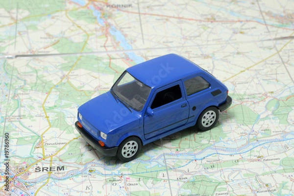 Obraz Tiny blue car model on the road map