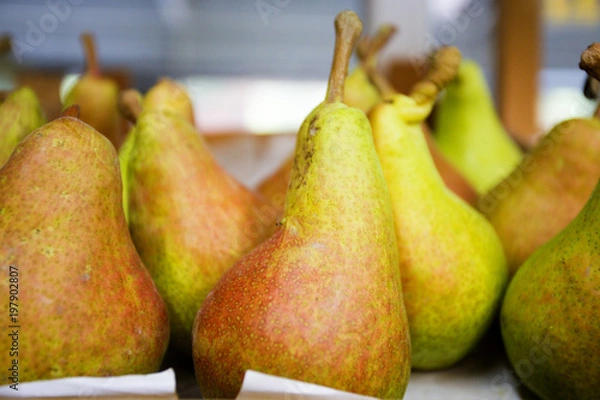 Fototapeta ripe juicy pear on the counter of the store