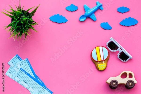 Fototapeta Sample of airplane ticket. Family trip with kid. Airplan, car and air balloon toys. Pink background flat lay space for text