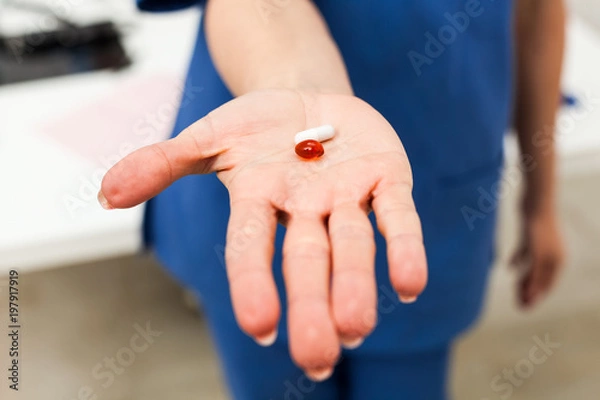 Fototapeta Nurse lending a pill