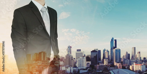 Fototapeta Double exposure, Businessman and city skyscraper view in sunrise background