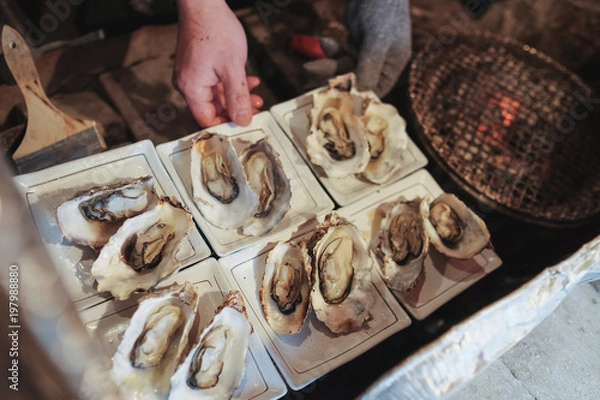 Fototapeta Chef grilled oysters meticulously. To serve tourists arriving at matsushima bay