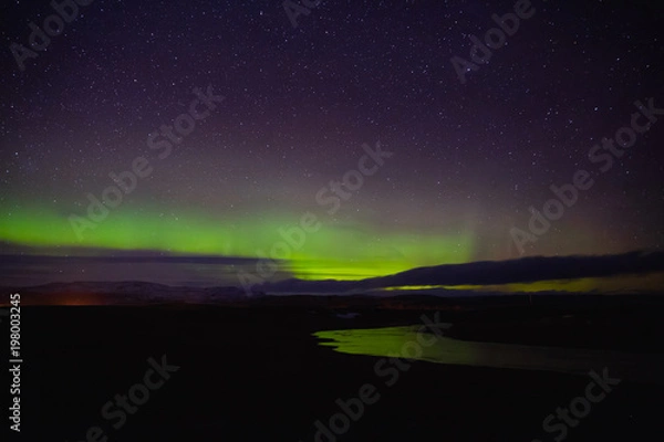 Fototapeta majestic view of night sky with northern lights and stars in iceland