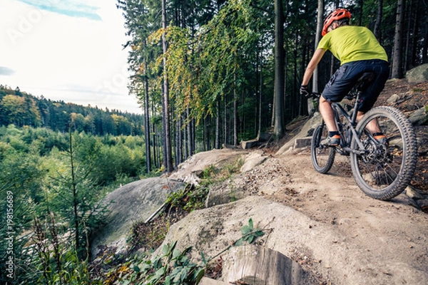 Obraz Mountain biker riding cycling in autumn forest