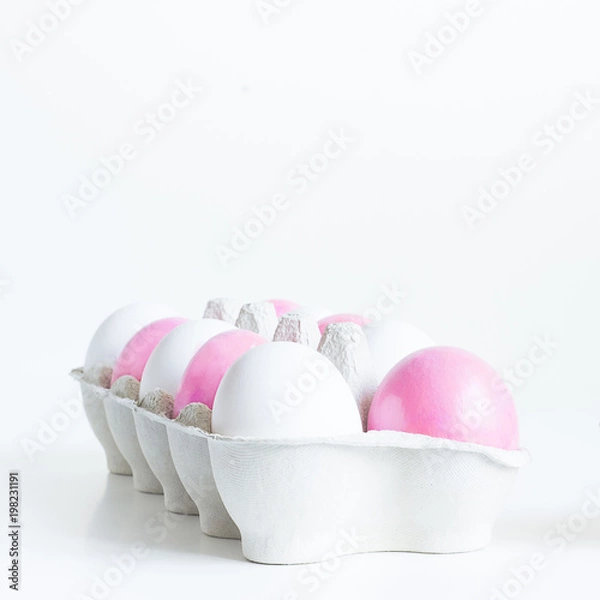 Obraz Pink and white Easter eggs in craft egg stand