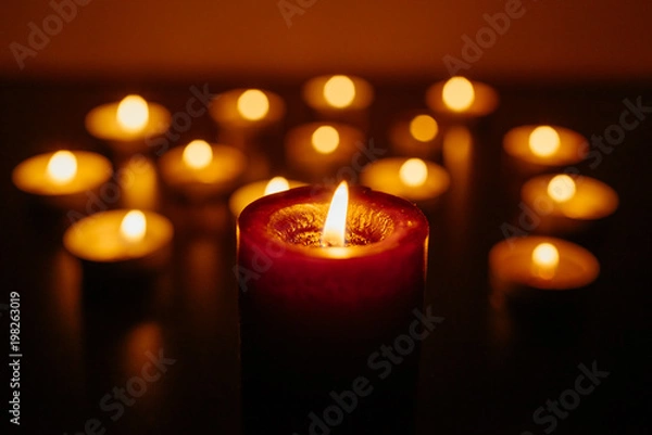 Obraz Kemerovo, Russia, fire in the mall, burning candles. Shallow depth of field. Many candles burning at night. Candles background. Many candle flames glowing on dark background. Close-up. Free space.