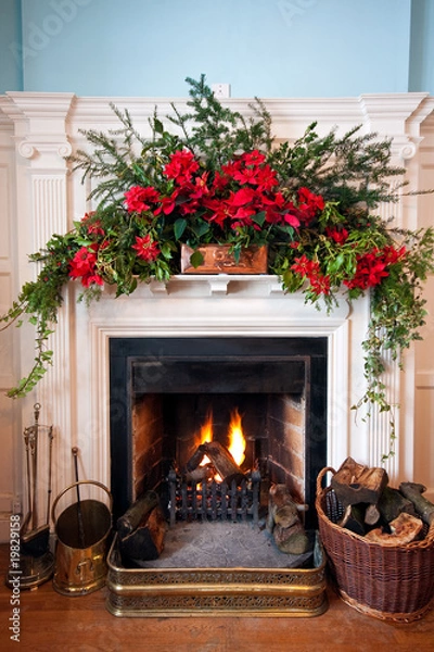Fototapeta Beatifully decorated fireplace with lit fire