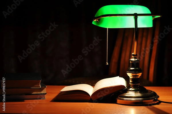 Obraz Electric green table lamp and opened book