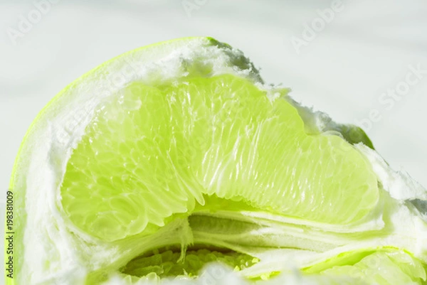Obraz lime slice, slice of green lime orange pamela. Fresh citrus on white background