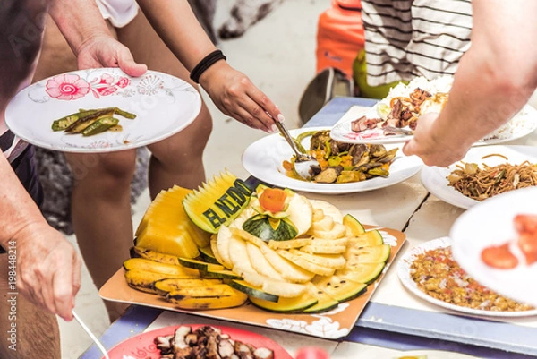 Obraz Hungry people are having a lunch with fruit plate with El Nido text cut, Palawan island, Philippines