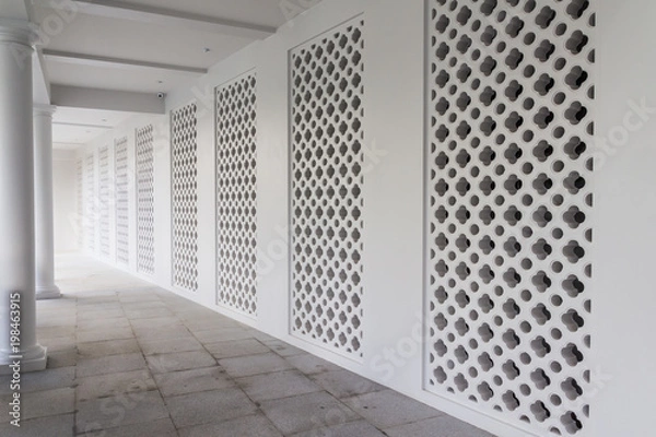 Fototapeta Walk walk of old style hotel with hollow concrete block wall