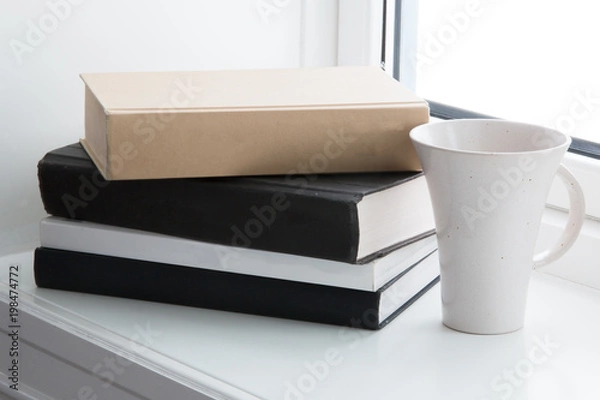 Fototapeta books and cup in window