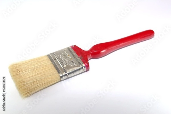 Fototapeta Paint brush width 2 inches with a red handle on a white background close-up