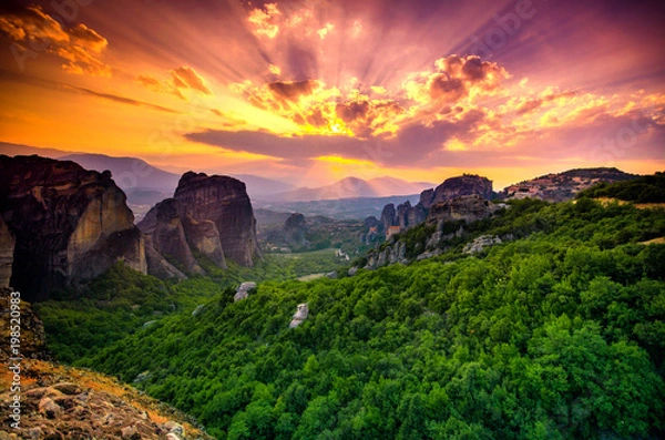 Fototapeta Breathtaking view of Meteora at sunset, Greece. Geological formations of big rocks with Monasteries  on top of them.