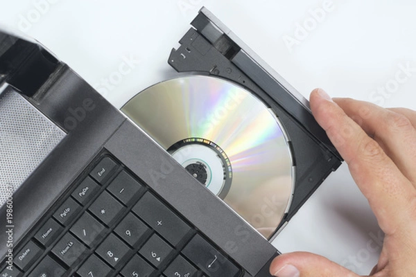 Obraz insert disk into laptop