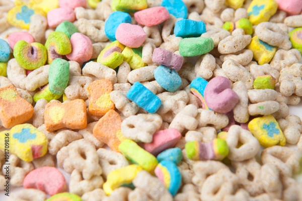 Fototapeta Frosted toasted oat cereal with fun shaped marshmallows on white background.