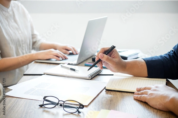 Fototapeta Two high school students campus or classmates with helps friend studying for a test an exam in workbook learning in classroom, Tutor books with friends, Education school concept