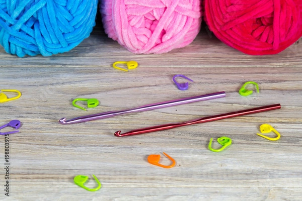 Obraz Pastel colored yarn on the wooden table crochet hooks