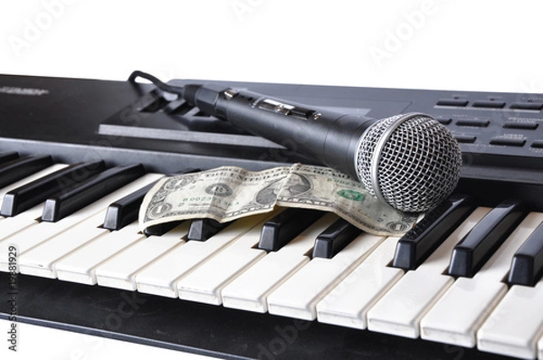 Fototapeta A microphone and dollar lying on the keys