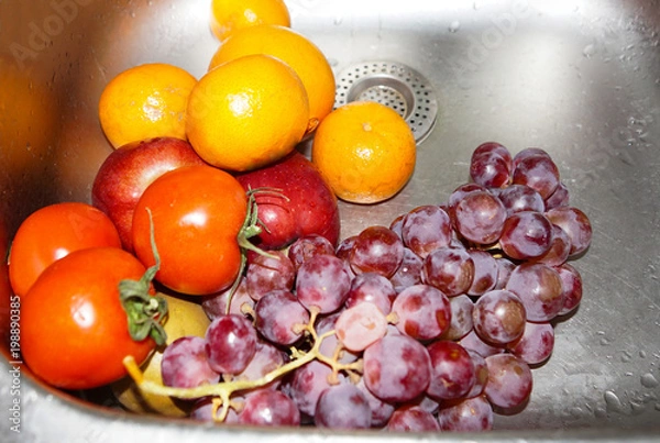 Fototapeta Washed vegetables. Vegetables under the running water in the sink. Fresh vegetables close-up.