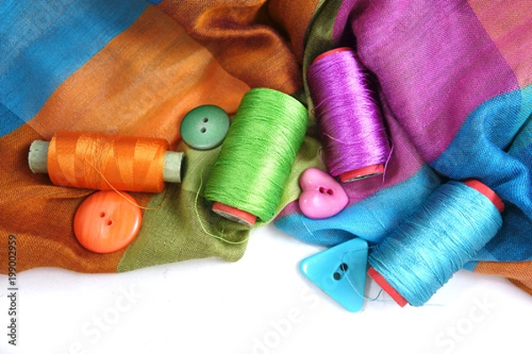 Fototapeta Multicolored accessories for sewing, bright threads, buttons and cloth