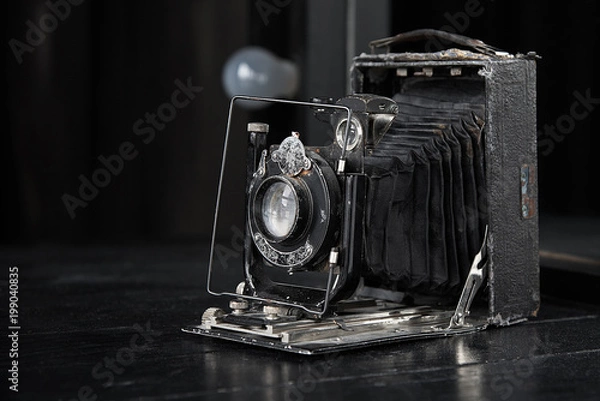 Obraz retro photo camera on a dark table