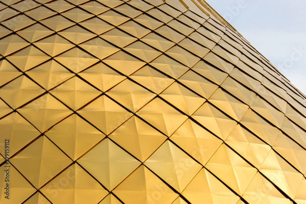 Fototapeta Close up shot of a golden dome of a church, cathedral or mosque. Background metal yellow rectangle pattern