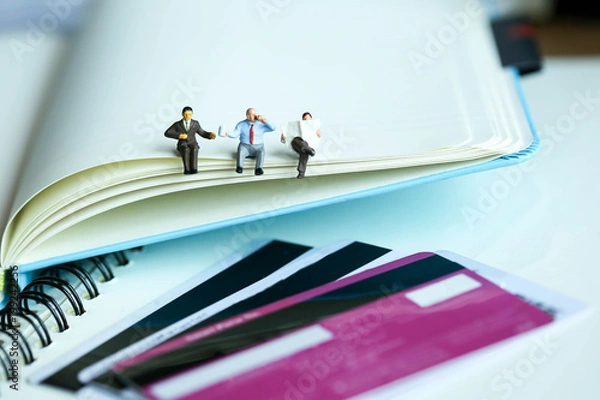 Fototapeta Miniature people : reading stand on book using as background education or business concept.