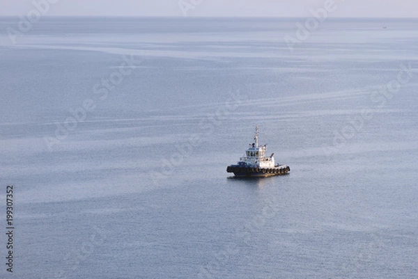 Fototapeta Tug boat stands without traffic in the sea. Tug boat alone in the sea