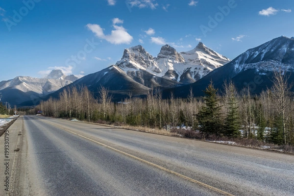 Fototapeta Road and Three Sisters mountains, adventure and travel. Canmore, Canada